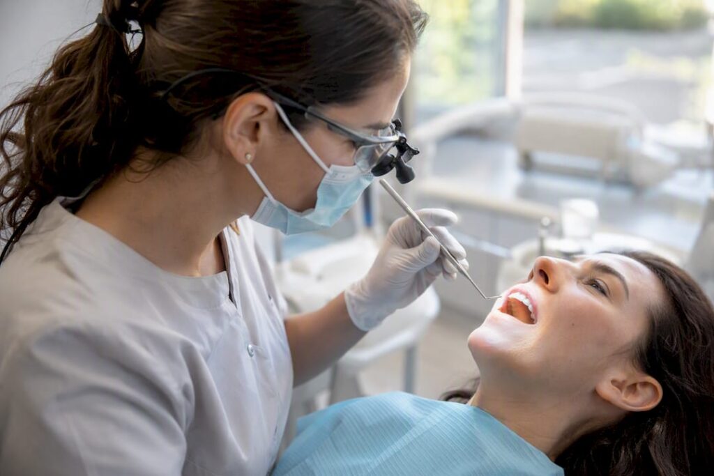 Dentist examining cracked tooth closely