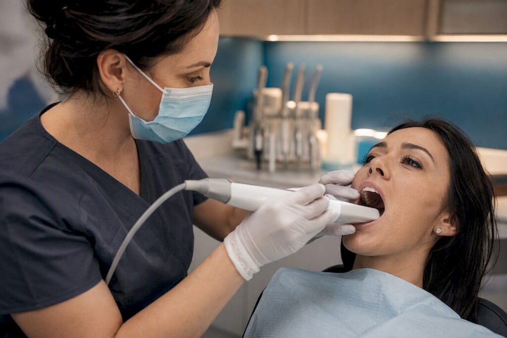Dental professional using 3D scanner on patient teeth